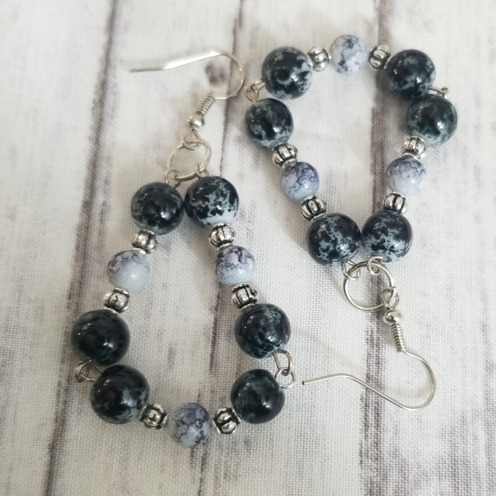 Black, white and silver toned dangle earrings